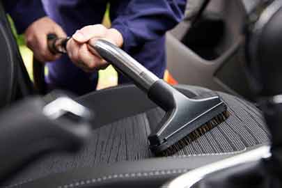 Cleaning and vacuuming the car's interior and exterior